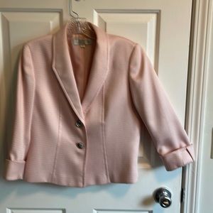 Pink blazer with 3/4 length sleeves.